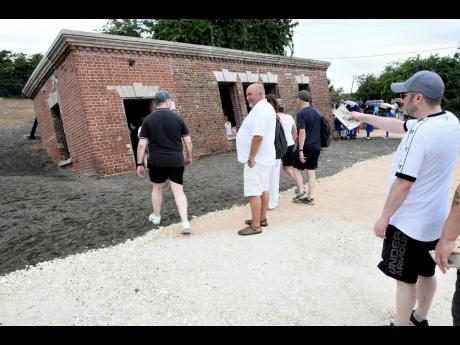 Visitors tour Giddy House in Port Royal, Kingston.