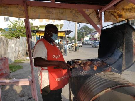 Brown prepares some of his famous jerk chicken.