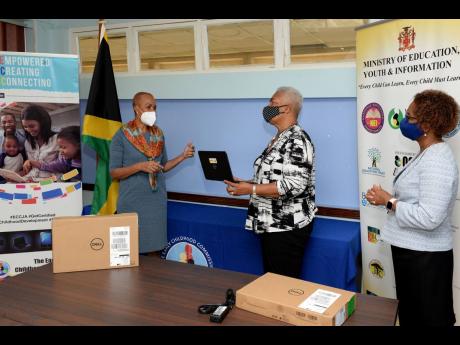 Education, Youth and Information Minister Fayval Williams (left) speaks with Chair of the Usain Bolt Foundation, Winsome Wilkins, during the handover of 150 Dell laptop computers at the ministry’s National Heroes Circle offices in Kingston last Friday.