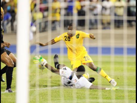Jamaica’s Tremaine Stewart moves past Antigua and Barbuda’s goalkeeper Molvin James during a World Cup qualifier at the National Stadium in 2012.
