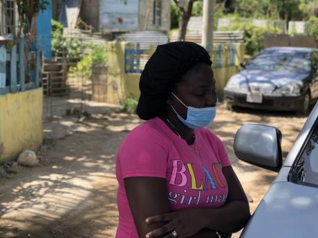 Peta-Gaye Dickenson, the wife of late footballer Tremaine Stewart, speaks with reporters yesterday following the sudden death of her husband on Sunday.