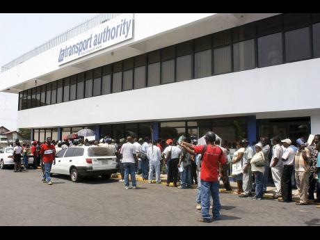 Credit: File File photo shows owners and operators of public passenger vehicles outside the Transport Authority’s offices on Maxfield Avenue.