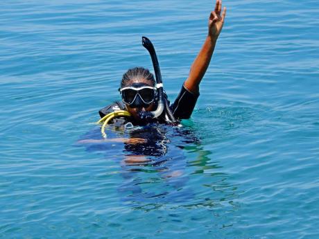 LEFT: Jay James gives the OK sign as she prepares to dive. 