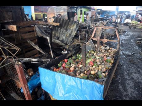 Credit: Nicholas Nunes Vendors who operate from Oxford Mall Arcade in downtown Kingston suffered a major setback after fire destroyed a section of the market late Sunday night.