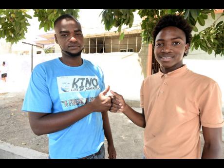 Tremayne Brown (left) gets a hail from Renardo Reynolds, who he saved from being washed away in Trench Town, St Andrew, four years ago.
