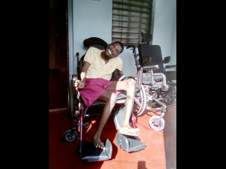 Robert Grant, a young man with cerebral palsy, makes himself comfortable in his newly gifted wheelchair.