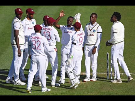 FILE
The West Indies Kemar Roach (centre) celebrates with his teammates after taking the wicket of New Zealand’s Tom Latham during play on day one of the first cricket Test against New Zealand in Hamilton, New Zealand, Thursday, December 3, 2020. 