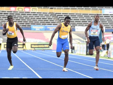 Bryan Levell (right) picks up points for Edwin Allen High School in the Class One Boys 100m final.  Sachin Dennis (centre) of St Elizabeth Technical High School took the gold medal, while Antonio Watson of Petersfield High School took silver.