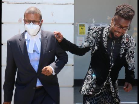 Dancehall superstar Beenie Man (right) and his attorney, Roderick Gordon, leave the St Elizabeth Parish Court yesterday after the artiste was fined $150,000 for breaching the Disaster Risk Management Act.  
