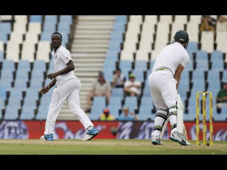West Indies’ bowler Kemar Roach (left) looks on after an unsuccessful appealing for LBW against South Africa’s batsman AB de Villiers during a Test match at Centurion Park in Pretoria, South Africa on Wednesday, December 17, 2014.