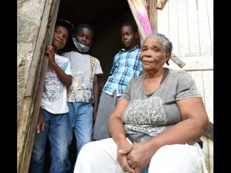 Lerline Earle (right) with her grandsons (from left) Sean, Quwayne and Damion Creary at their home in Swain Spring, St Andrew.