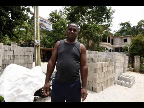 Businessman Tyrone Davis does what he can to help smooth out the roadway.