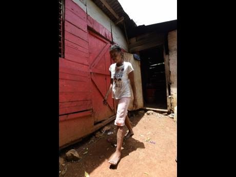 Whyte walks around a side of the one-bedroom house.