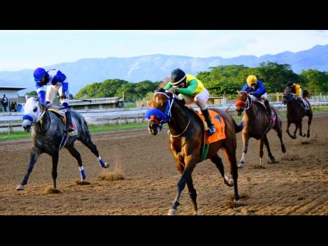 Credit: File FATHER PATRICK (right), ridden by Oshane Nugent, wins the St Catherine Cup over 1200 metres at Caymanas Park on January 16, 2021. DUKE (left), with Robert Halledeen aboard, was second.