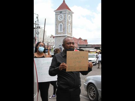 Denton ‘Blush Boss’ Atkins, president of the Clarendon Promoters Association, leads the protest.
