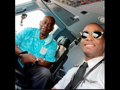 Credit: Contributed Anselm Dewar (right) and his father, Ashman, in the pilot’s cockpit, aboard the flight on June 5.