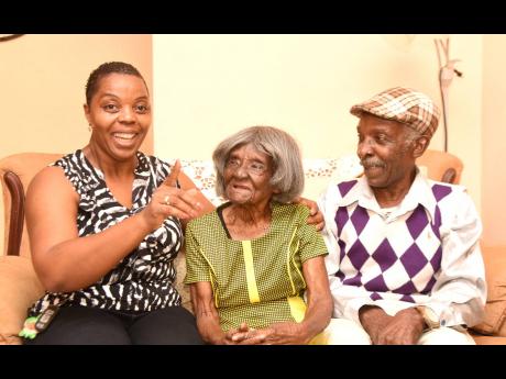 Credit: Kenyon Hemans 1. Ivy Allen (centre) listens keenly to her granddaughter Carla Silvera-Cox. Looking on is Allen’s son Morris Henry.