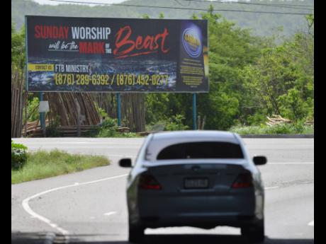 This billboard located at the intersection of Lakes Pen Road and Municipal Boulevard in Portmore, St Catherine, one of three mounted to warn Sunday worshippers about the Mark of the Beast.