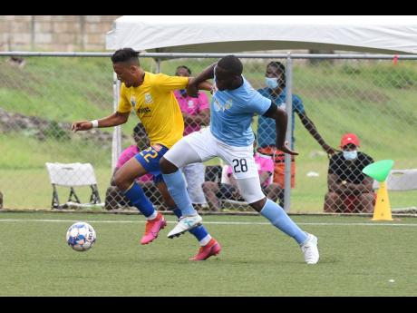 Harbour View’s Oquassa Chong (left) getting away from Shawn Dewar of Waterhouse during a  Jamaica Premier League match on Monday, June 28.