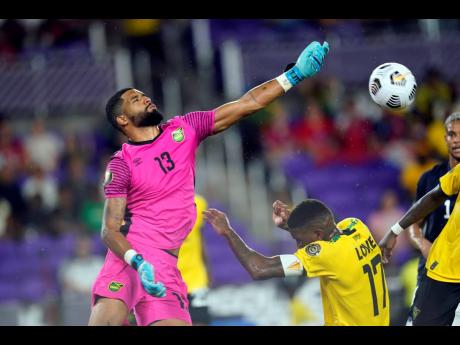 Jamaica’s goalkeeper Dillon Barnes (13) blocks a shot from a  Costa Rican player during the first half of last night’s Concacaf Gold Cup Group C  match in  Orlando, Florida. 