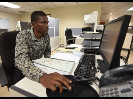 Credit: Ian Allen Omar Moodie, a former windshield wiper, is now a record officer at the Ministry of Housing, Urban Renewal, Environment and Climate Change.