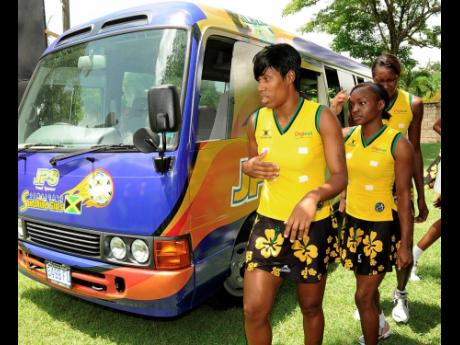 File
Sunshine Girls Kasey Evering (left), Sateva Taylor (centre) and Romelda Aiken walk next to one of the    netball team buses shortly after it was presented to the Jamaica Netball Association by Jamaica Public Service Company Limited in August 2010.