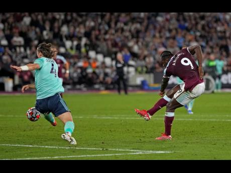 West Ham's Michail Antonio (right) scores his side's third goal during the English Premier League  match between West Ham United and Leicester City and at the London Stadium in England on Monday. West Ham won 4-1.