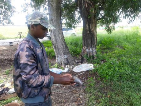 Jerome scales one of the fishes.