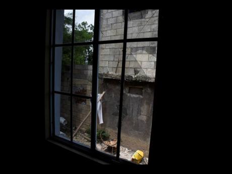 Gunmen fired through the window of this home in Windsor Heights, Central Village, St Catherine early Thursday morning, killing Kowain Findlay and injuring his girlfriend.