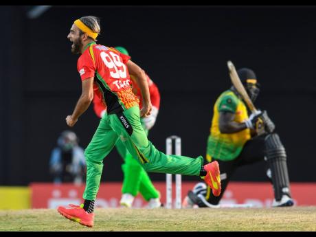 Photo by Randy Brooks - CPL T20/Getty Images

Imran Tahir (left) of Guyana Amazon Warriors celebrates the dismissal of Kennar Lewis (right) of Jamaica Tallawahs during the 2021 Hero Caribbean Premier League match 29 between Guyana Amazon Warriors and Jamaica Tallawahs at Warner Park Sporting Complex on Sunday in Basseterre, St Kitts, Saint Kitts and Nevis.