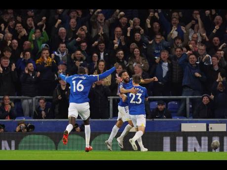 Everton's Andros Townsend (centre) celebrates scoring his side's second goal during their English Premier League match against Burnley at Goodison Park, Liverpool, England on Monday. Everton won 3-1.