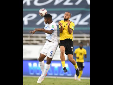 Kemar Roofe (right) in action for Jamaica against Panama’s Fidel Escobar Mendieta during their Concacaf World Cup qualification match at the National Stadium on Sunday, September 5.