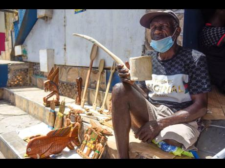 Benneth shows off one of his creations, a wooden pipe.