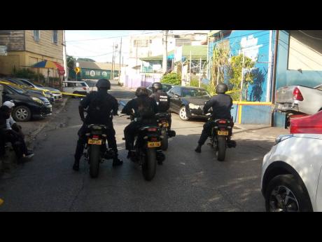Security personnel on the scene at yesterday's triple killing in Montego Bay.