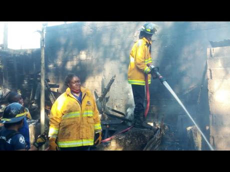 Firefighters carry out cooling-down operations.