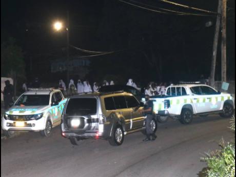 Members of the Jamaica Constabulary Force outside the church in Montego Bay on Sunday night.