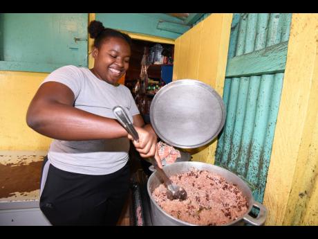 Ashanti James readies a pot of rice and peas in her cookshop in  Bellas Gate, St Catherine.