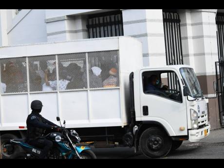 Alleged members of the One Don Gang being transported to court.