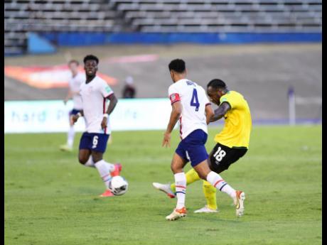 Credit: Gladstone Taylor Michail Antonio (right) scores
Jamaica’s equaliser from outside the box during yesterday’s Concacaf World Cup qualifier against the United States at the National Stadium. The game ended in a 1-1 draw.