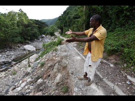 Furgos Bernard complains that the authorities are taking too long to fix a section of the road that was washed away during heavy rains in 2020.