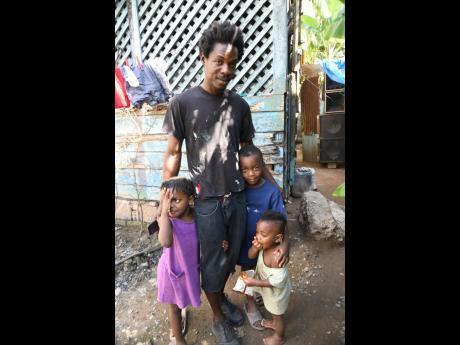 Kevin Wilson, with three of his children, at home at Lenwood Path, St Andrew.