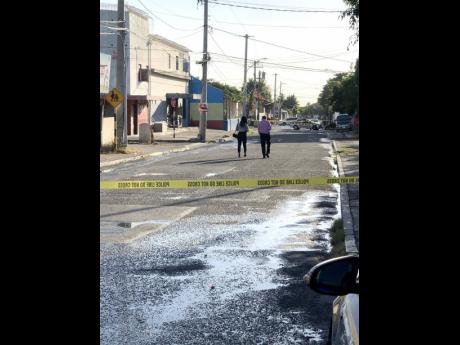 Police process the scene on Fitzgerald Avenue where four persons were shot yesterday.