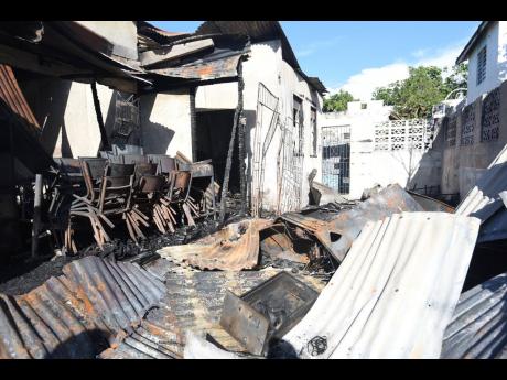 Fire of unknown origin destroyed a house, basic school and damaged a section of Archer’s Funeral Home on Young Street, Spanish Town, St Catherine, yesterday.