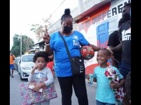 Credit: Contributed Children in Tivoli Gardens happily receive their toys.