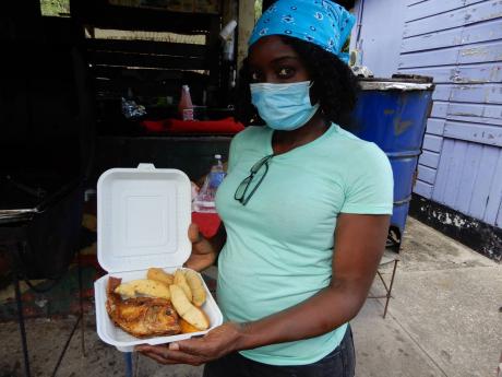 Hirfa Brown-Gordon serves up a meal of fish and breadfruit.