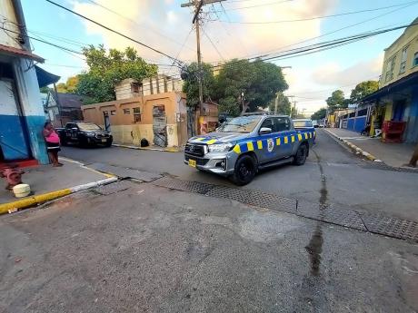Credit: Roxroy McLean A police unit along Georges Lane in Central Kingston following yet another murder yesterday.
