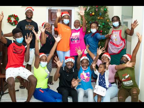 Members of the Franklyn Town Church of God and Digicel’s Public Relations Executive, Jody-Ann Fearon strike a celebratory pose at the Christmas Tree. Digicel and the Digicel Foundation donated toys and a cash grant of $30,000 toward the Christmas treat held on the church grounds.