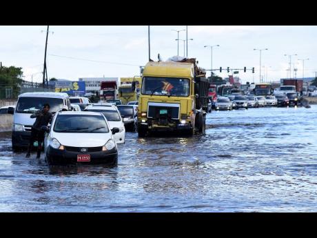 Credit: FILE Motorists stuck in traffic along a section of Marcus Garvey Drive in the vicinity of the Tinson Pen Aerodrome that was flooded after afternoon showers.