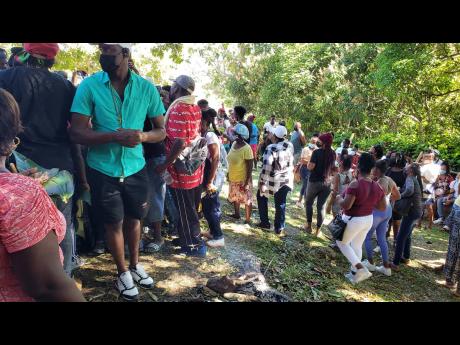 Credit: Ashley Anguin Scores of Maroons taking part of the Pork Ritual which is a big part of the festival under the Kindah Tree in Accompong, St Elizabeth, on Thursday.