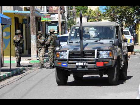 Credit: Ricardo Makyn Members of the Jamaica Defence Force on Gold Street in the Parade Gardens community in central Kingston. The area was declared a zone of special operations.